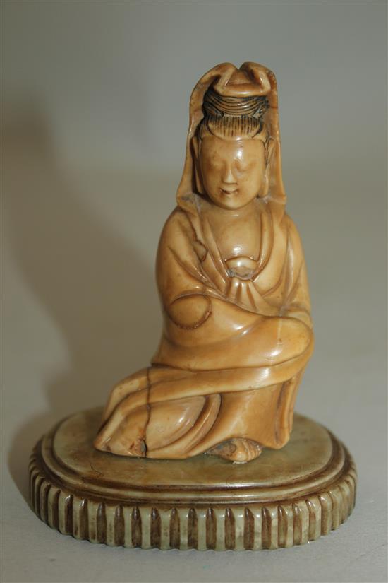 A Chinese soapstone seated figure of Guanyin, 17th / 18th century, 10cm, label for R & V Tregaskis